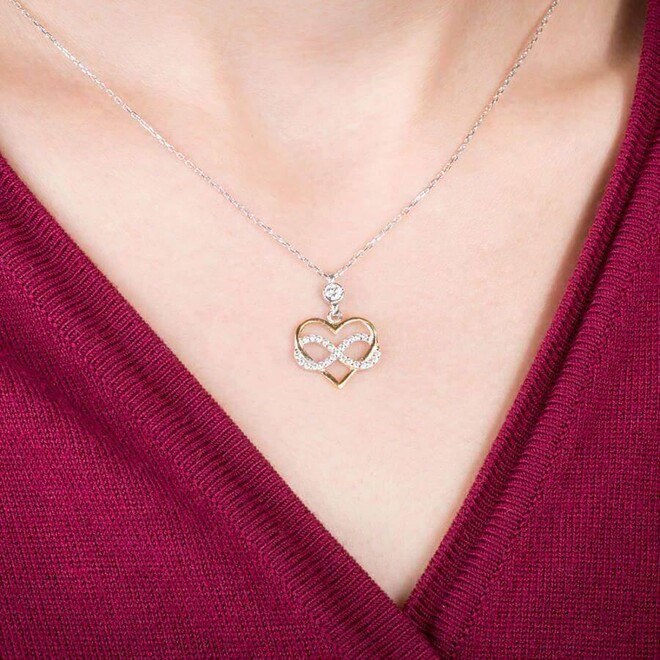 An infinity symbol silver necklace for women studded with zircon stone and a golden heart - 2
